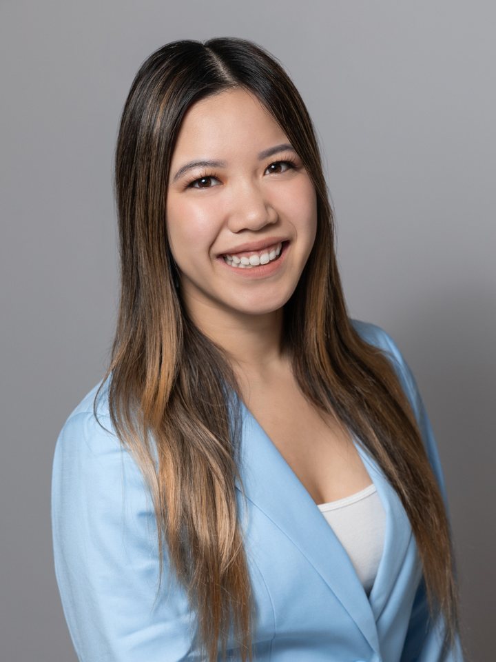 Tiffany Tran smiling, wearing a light blue blazer